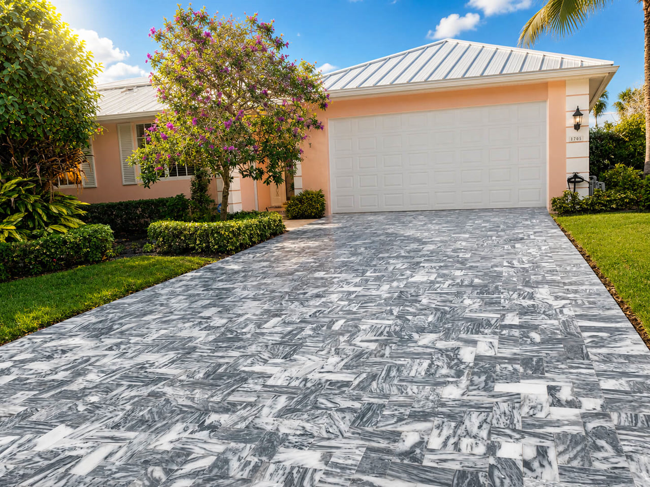 Gray veined marble driveway pavers in herringbone leading to the garage at a Delray Beach residence