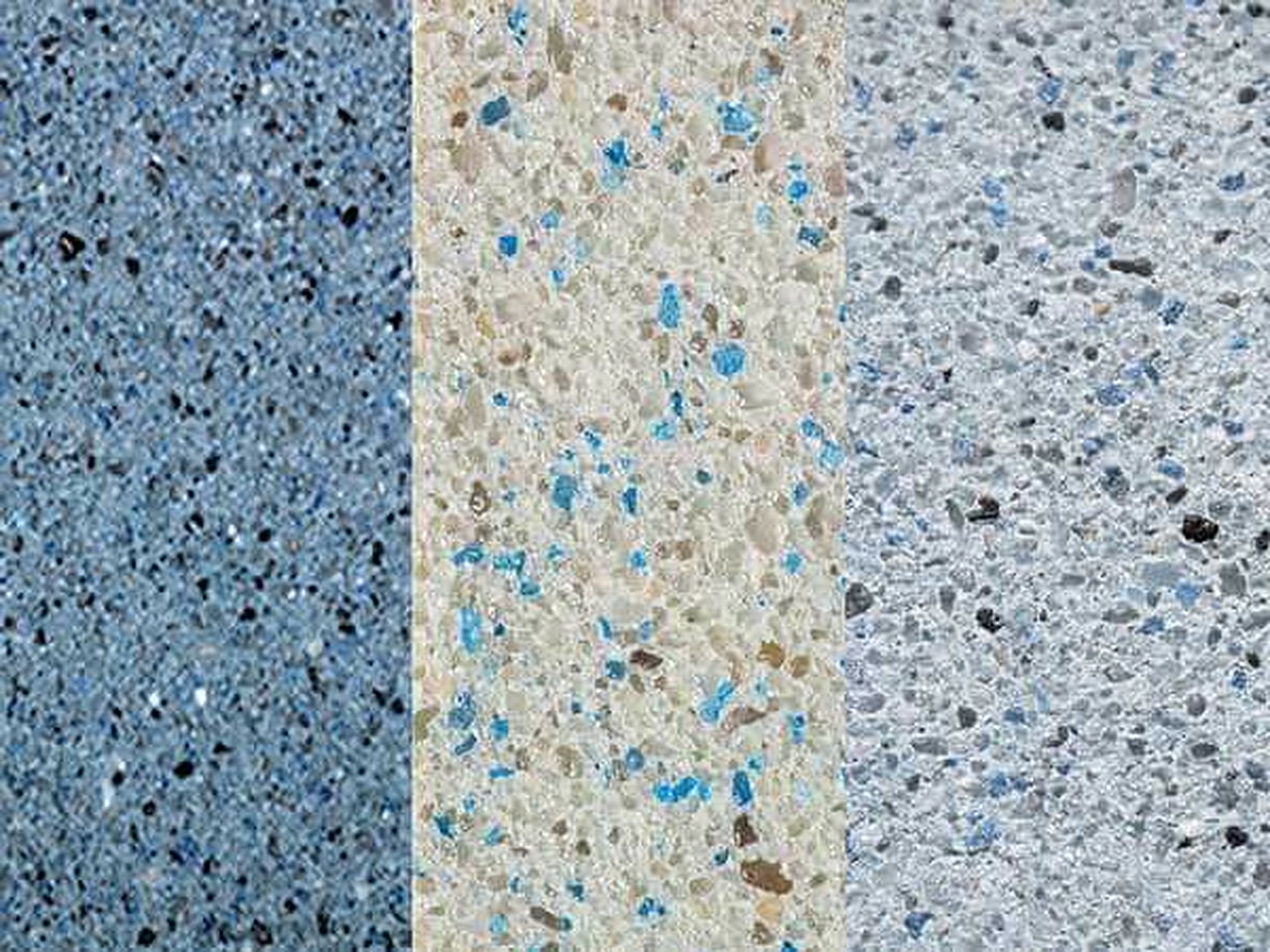 Three gem aggregate pool finish samples side by side, from steel blue to cream and pale gray with blue glass flecks, for a Loxahatchee homeowner