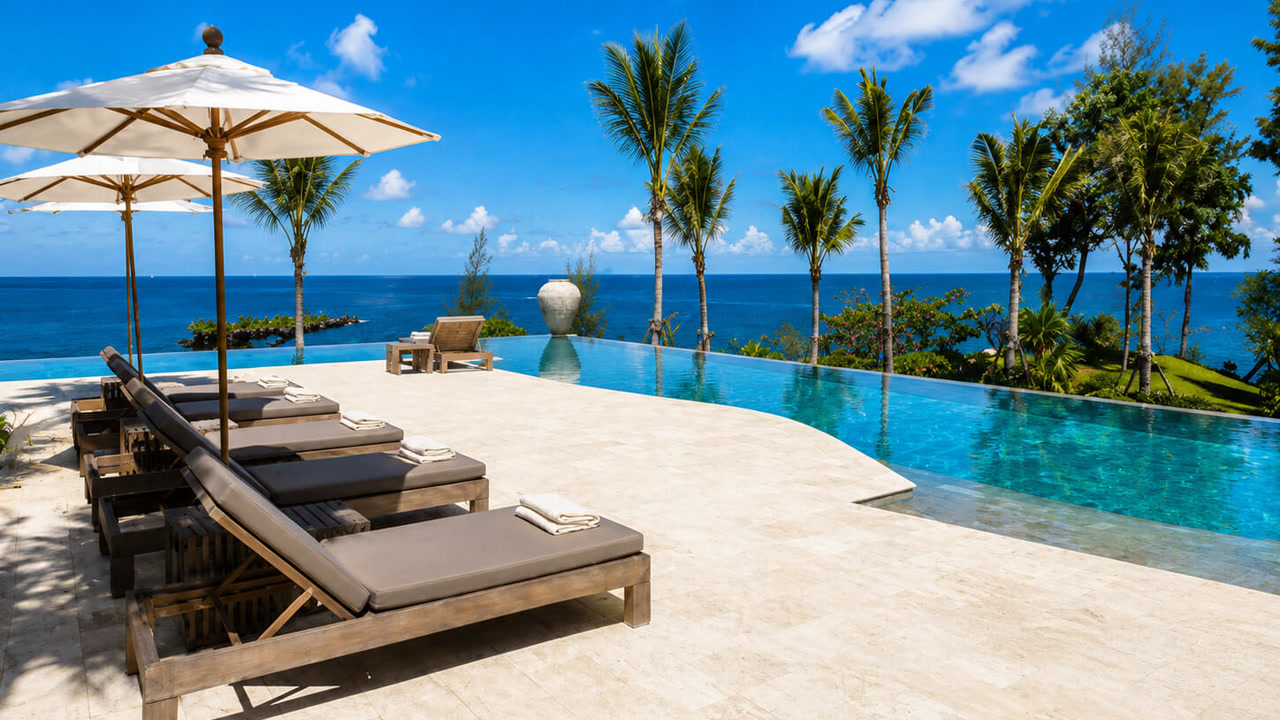 Renovated travertine paver pool deck around an infinity edge pool with an ocean view